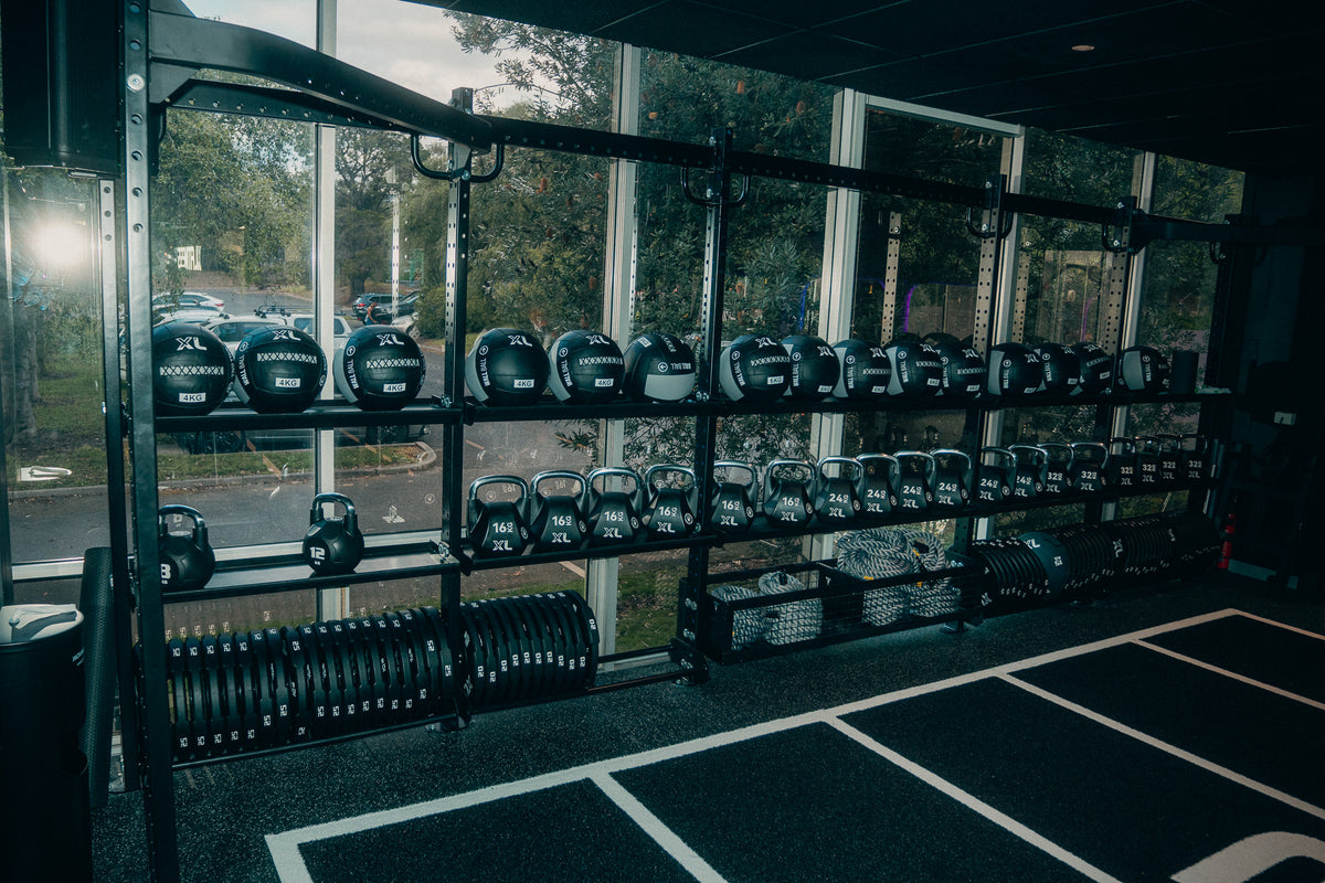 XL wall balls, kettlebells and training equipment beside the Hybrid turf lanes